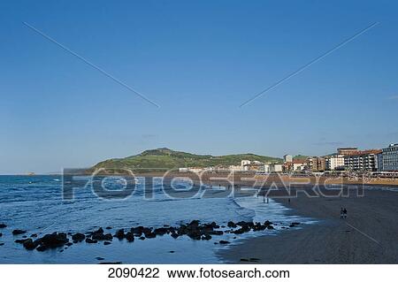 Stock Image - Sunbathing On The Beach, Zarautz, Basque Country, Spain. Fotosearch
