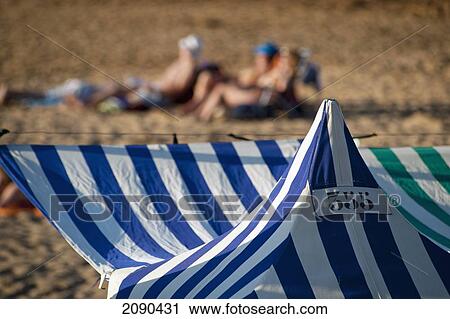 Stock Image - Sunbathing On The Beach, Zarautz, Basque Country, Spain. Fotosearch