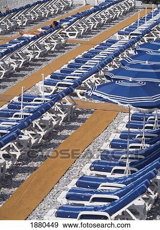 Stock Photo - Sunbeds On Beachfront Of Nice. Fotosearch