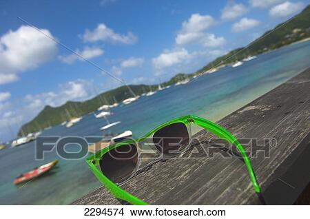 Sunglasses with Tyrell Bay in background; Carriacou Island in the Grenadines. Grenada. Caribbean View Large Photo Image Picture - Sunglasses with Tyrell Bay in background; Carriacou Island in the Grenadines. Grenada. Caribbean. Fotosearch