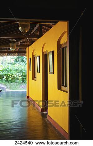 Stock Image - Sunlight illuminating a yellow wall; Ulpotha, Embogama, Sri Lanka. Fotosearch