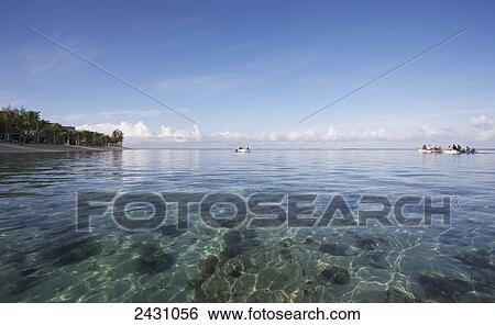 Sunlight reflecting in the clear, shallow water of the Indian Ocean off the coast of an island; Mauritius View Large Photo Image Stock Photograph - Sunlight reflecting in the clear, shallow water of the Indian Ocean off the coast of an island; Mauritius. Fotosearch