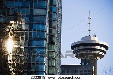Stock Photo - Sunlight Reflection On Skyscraper Near Harbor Centre Building, Downtown; Vancouver, British Columbia, Canada. Fotosearch