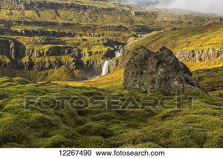 Sunlight shines through storm clouds and illuminates the hillsides of Iceland's East Fjord region; Iceland View Large Photo Image Stock Image - Sunlight shines through storm clouds and illuminates the hillsides of Iceland's East Fjord region; Iceland. Fotosearch