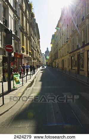 Sunlight shining onto a walkway with pedestrians, Marais district; Paris, France View Large Photo Image Stock Photo - Sunlight shining onto a walkway with pedestrians, Marais district; Paris, France. Fotosearch