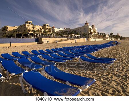 Stock Image - Sunloungers On Sandy Beach; Cabos San Lucas, Los Cabos, Mexico. Fotosearch