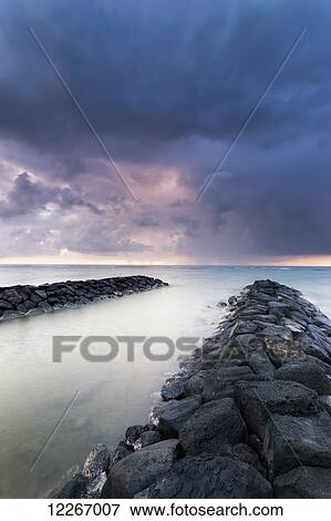 Sunrise and storm clouds looking out over breakwater; Kapaa, Kauai, Hawaii, United States of America View Large Photo Image Stock Photo - Sunrise and storm clouds looking out over breakwater; Kapaa, Kauai, Hawaii, United States of America. Fotosearch