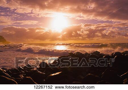 Sunrise and waves crashing on the rocks, Kealia Beach; Kauai, Hawaii, United States of America View Large Photo Image Stock Image - Sunrise and waves crashing on the rocks, Kealia Beach; Kauai, Hawaii, United States of America. Fotosearch