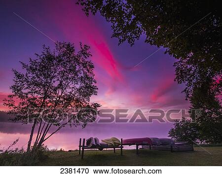 Sunrise explodes over Echo Lake in Aroostook State Park with canoes on the shore; Presque Isle, Maine, United States of America View Large Photo Image Stock Image - Sunrise explodes over Echo Lake in Aroostook State Park with canoes on the shore; Presque Isle, Maine, United States of America. Fotosearch