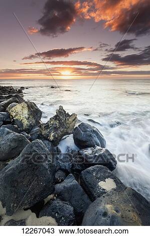 Stock Image - Sunrise from Lydgate Beach Park; Lydgate, Kauai, Hawaii, United States of America. Fotosearch