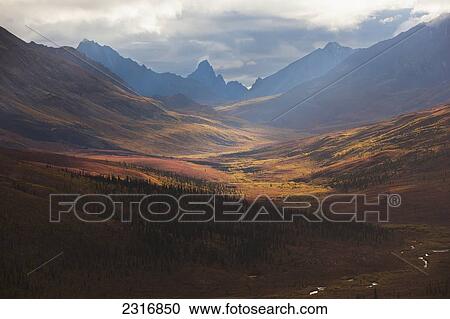 Stock Image - Sunrise Lights The Colors Of Autumn Over Klondike Valley In Tombstone Territorial Park; Yukon Canada. Fotosearch