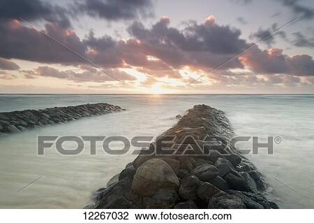Sunrise looking out over the breakwater; Kapaa, Kauai, Hawaii, United States of America View Large Photo Image Stock Image - Sunrise looking out over the breakwater; Kapaa, Kauai, Hawaii, United States of America. Fotosearch