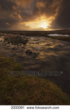 Stock Image - Sunrise Over A Flowing Stream; Snaefellsnes Peninsula, Iceland. Fotosearch