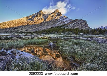 Sunrise Over A Peak Reflected In A Tarn Below Baker Lake In The Skoki Wilderness In Banff National Park; Banff Alberta Canada View Large Photo Image Stock Image - Sunrise Over A Peak Reflected In A Tarn Below Baker Lake In The Skoki Wilderness In Banff National Park; Banff Alberta Canada. Fotosearch