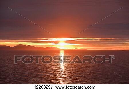 Stock Photo - Sunrise over Bristol Bay and Ahklun Mountains, Togiak National Wildlife Refuge and Walrus Islands State Game Sanctuary, Round Island, Bristol Bay, Western Alaska, USA.. Fotosearch