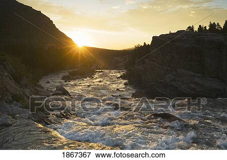 Sunrise Over Swift Current Creek, Glacier National Park; Montana, Usa View Large Photo Image Stock Photo - Sunrise Over Swift Current Creek, Glacier National Park; Montana, Usa. Fotosearch