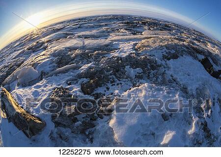 Sunrise over the Norton Sound sea ice during Iditarod; Alaska, United States of America View Large Photo Image Stock Photography - Sunrise over the Norton Sound sea ice during Iditarod; Alaska, United States of America. Fotosearch