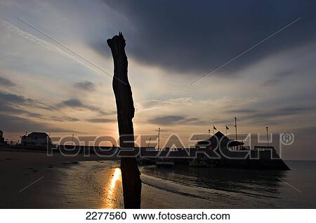 Stock Image - Sunrise over Viking Bay; Broadstairs, Kent, England. Fotosearch