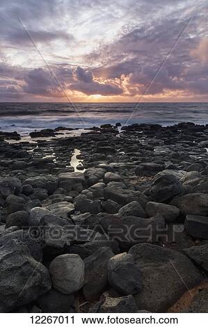 Sunrise seen from the rocks near the Lihue Airport; Lihue, Kauai, Hawaii, United States of America View Large Photo Image Stock Image - Sunrise seen from the rocks near the Lihue Airport; Lihue, Kauai, Hawaii, United States of America. Fotosearch