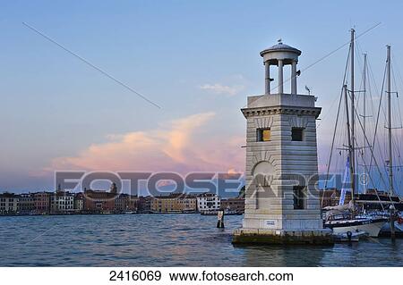 Sunset and the lighthouse at San Giorgio Maggiore, with Venice in the background; Venice, Italy View Large Photo Image Stock Photo - Sunset and the lighthouse at San Giorgio Maggiore, with Venice in the background; Venice, Italy. Fotosearch