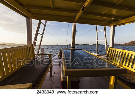 Sunset, as seen from a boat in Kima Bay by Rinca Island, Komodo National Park, East Nusa Tenggara, Indonesia View Large Photo Image Stock Photo - Sunset, as seen from a boat in Kima Bay by Rinca Island, Komodo National Park, East Nusa Tenggara, Indonesia. Fotosearch