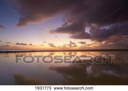Stock Image - Sunset Beside Shallow Pool, Brighton Beach, Barbados; Barbados. Fotosearch