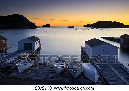 Stock Image - Sunset, Boats And Sheds, Back Harbour, Twillingate, Newfoundland & Labrador. Fotosearch