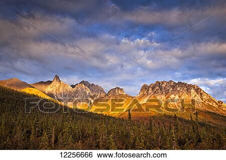 Stock Photograph - Sunset glow on Snowden Mountain in the Brooks Range, Dalton Hwy, Arctic Alaska, Autumn.. Fotosearch