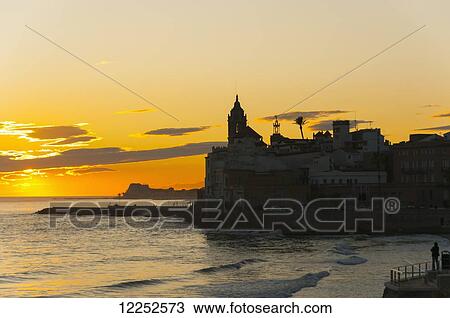 Stock Image - Sunset in the beautiful Sitges downtown, village near to Barcelona; Sitges, Spain. Fotosearch