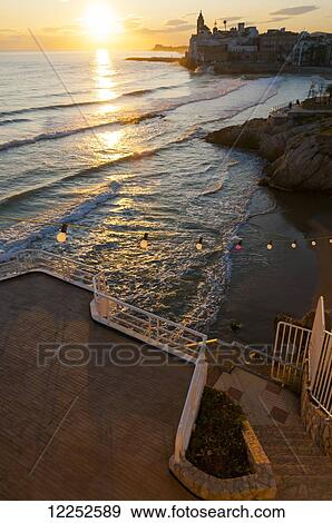 Sunset in the beautiful Sitges downtown, a village near to Barcelona; Sitges, Spain View Large Photo Image Stock Photo - Sunset in the beautiful Sitges downtown, a village near to Barcelona; Sitges, Spain. Fotosearch