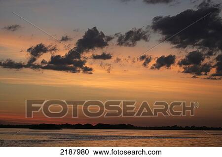 Stock Image - Sunset on the Zambezi; Namibia. Fotosearch