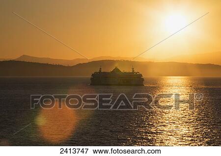 Stock Photo - Sunset over ferry in Strait Of Georgia between Tsawwassen and Swartz Bay on Vancouver Island; British Columbia, Canada. Fotosearch
