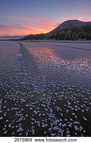 Stock Photo - Sunset Over Frozen Lake In Winter, Kusawa Lake Territorial Park, Yukon, Canada. Fotosearch