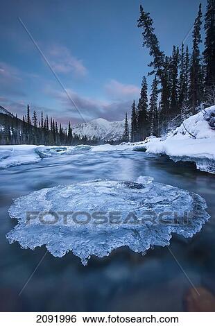 Sunset Over Ice-Covered Rock In Wheaton River; Yukon Canada View Large Photo Image Stock Photograph - Sunset Over Ice-Covered Rock In Wheaton River; Yukon Canada. Fotosearch