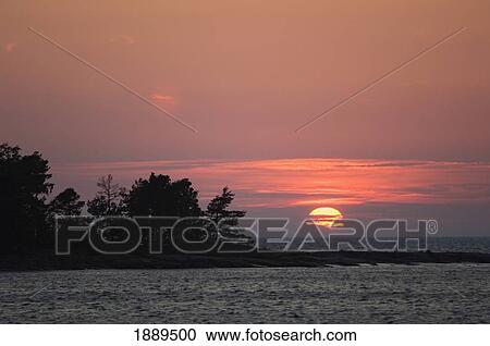Stock Image - Sunset Over Lake Vanern.. Fotosearch