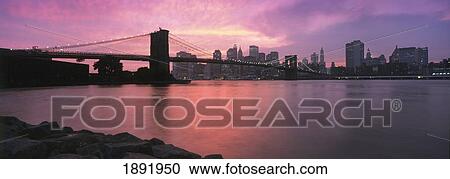 Stock Image - Sunset Over Lower Manhattan And Brooklyn Bridge. Fotosearch