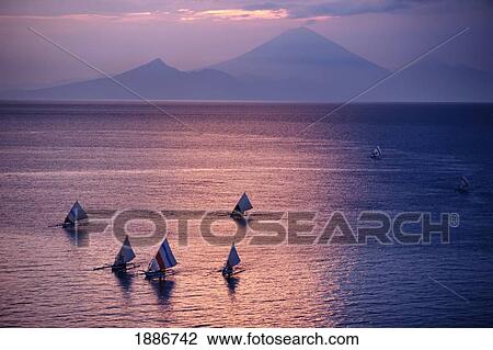 Stock Image - Sunset Over Sea, Mount Agung, Bali. Fotosearch