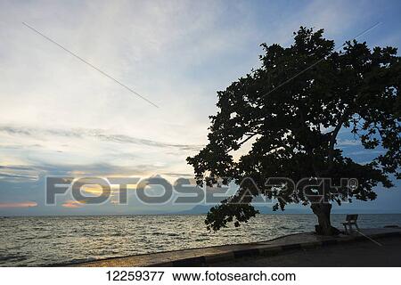 Sunset over the ocean; Kep, Cambodia View Large Photo Image Stock Photo - Sunset over the ocean; Kep, Cambodia. Fotosearch