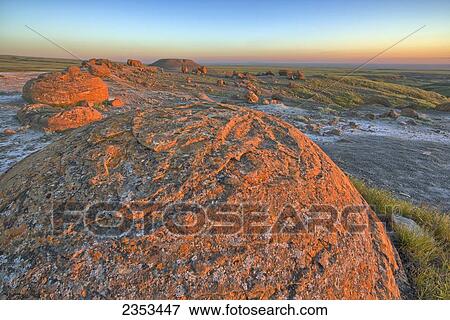 Stock Photo - Sunset Over The Rocks At Red Rock Coulee; Alberta, Canada. Fotosearch