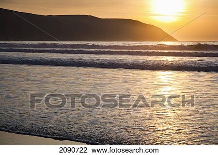 Sunset Over The Sea And Beach In Putsborough Sands, North Devon, Uk View Large Photo Image Stock Image - Sunset Over The Sea And Beach In Putsborough Sands, North Devon, Uk. Fotosearch