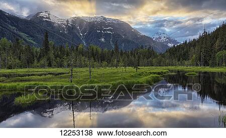 Stock Photo - Sunset over the Tongass National Forest near Hyder; Alaska, USA. Fotosearch