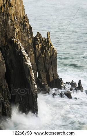 Stock Photo - Surf breaks on the rocks; Manzanita, Oregon, United States of America. Fotosearch