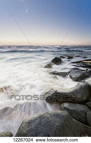 Picture - Surf washing up around rocks; Wailua, Kauai, Hawaii, United States of America. Fotosearch