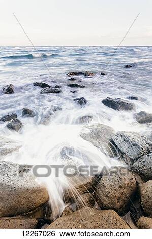 Surf washing up around rocks; Wailua, Kauai, Hawaii, United States of America View Large Photo Image Stock Photograph - Surf washing up around rocks; Wailua, Kauai, Hawaii, United States of America. Fotosearch