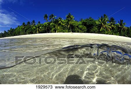 Stock Image - Surface Waves Ripple Near The Sandy Shoreline; Island Of Foa, Ha'apai, Kingdom Of Tonga. Fotosearch