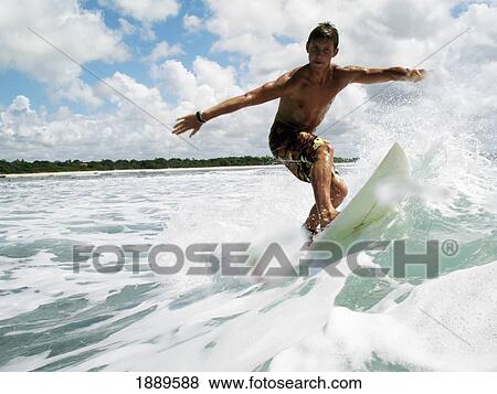Stock Photo - Surfer Balancing On Board, Low Angle View. Fotosearch