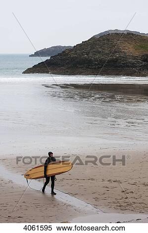 Surfer coming out of the chilly winter waters heading to car park at Whitesands Beach on the Pembrokeshire Coast Path; Pembrokeshire, Wales View Large Photo Image Stock Photography - Surfer coming out of the chilly winter waters heading to car park at Whitesands Beach on the Pembrokeshire Coast Path; Pembrokeshire, Wales. Fotosearch