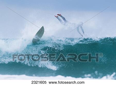 Surfer diving into water off his surfboard; Tarifa, Costa de la Luz, Cadiz, Andalusia, Spain View Large Photo Image Stock Photography - Surfer diving into water off his surfboard; Tarifa, Costa de la Luz, Cadiz, Andalusia, Spain. Fotosearch