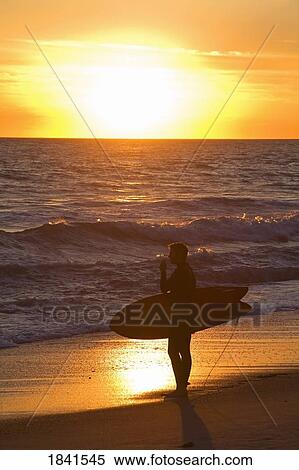 Stock Photography - Surfer Enjoying Sunset At San Clemente Beach; San Clemente, California, Usa. Fotosearch