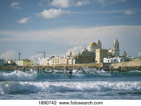Stock Image - Surfer In Front Of Santa Cruz Cathedral. Fotosearch